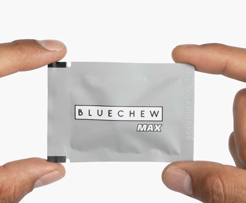 man holding up a closed grey packet of bluechew max combo vardenafil and tadalafil 