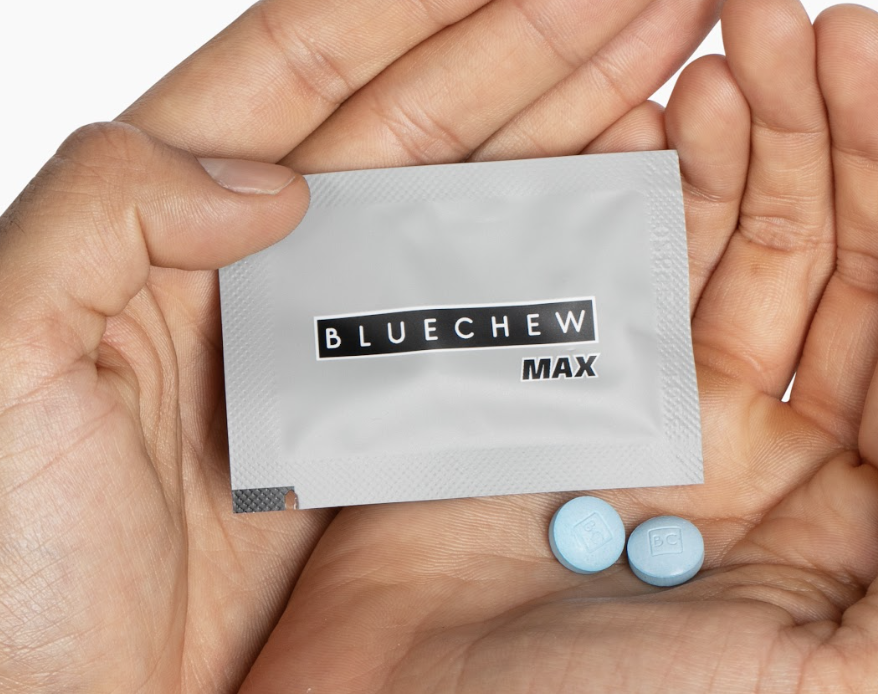 mans hand holding a packet of bluechew max combo sildenafil + tadalafil with pills in his hand