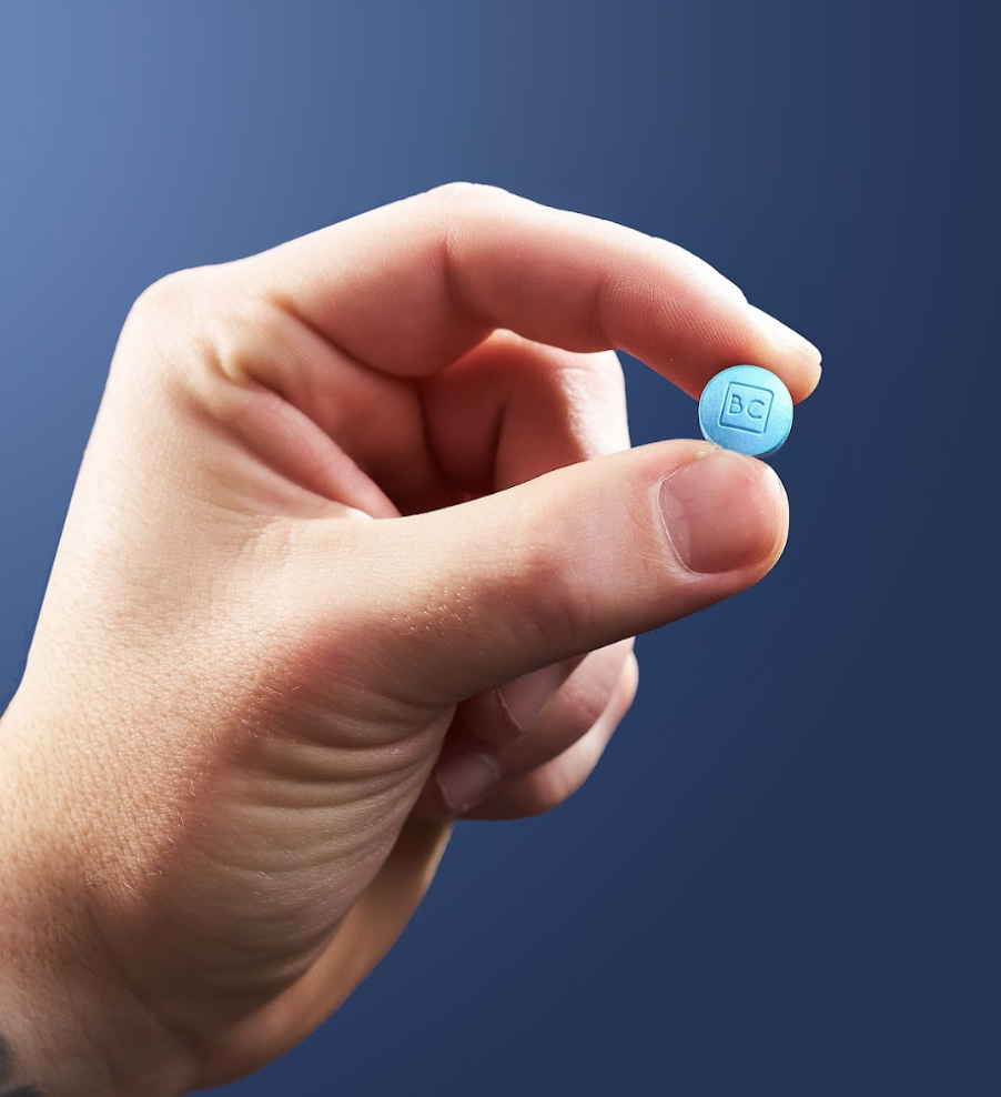 hand holding single bluechew erection-enhancing medication