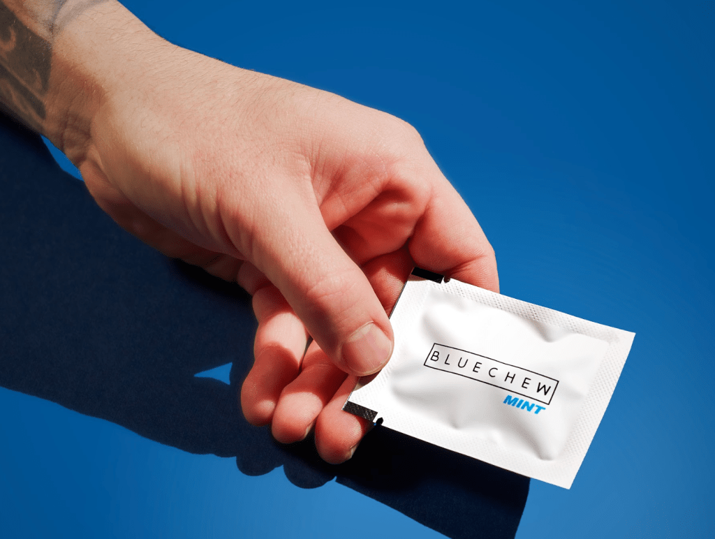 man holding white vardenafil erectile dysfunction medication from bluechew