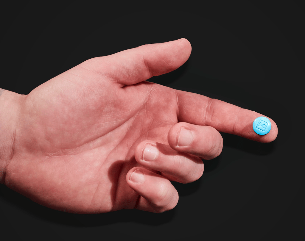 singel bluechew tablet on pointer finger