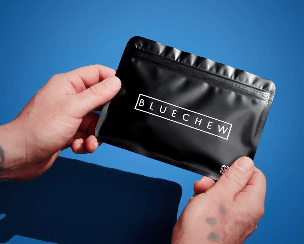 man holding bluechew packet containing erectile dysfunction compounded chewable tablets